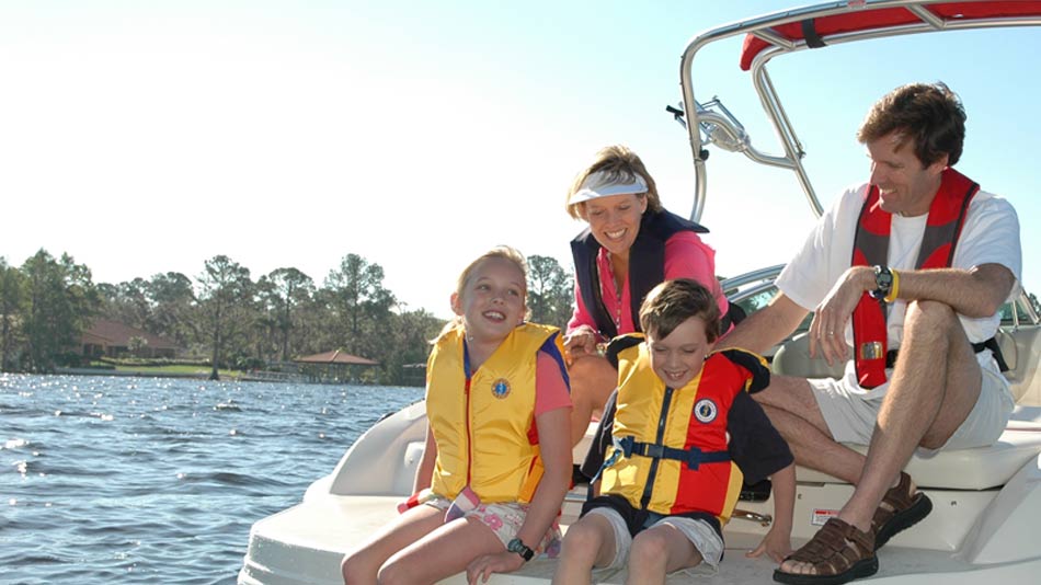 Family wearing life jackets aboard a boat